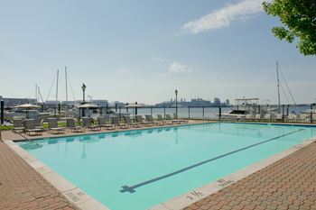 a swimming pool with a view of the harbor and the city at Tindeco Wharf, Baltimore, MD 21224